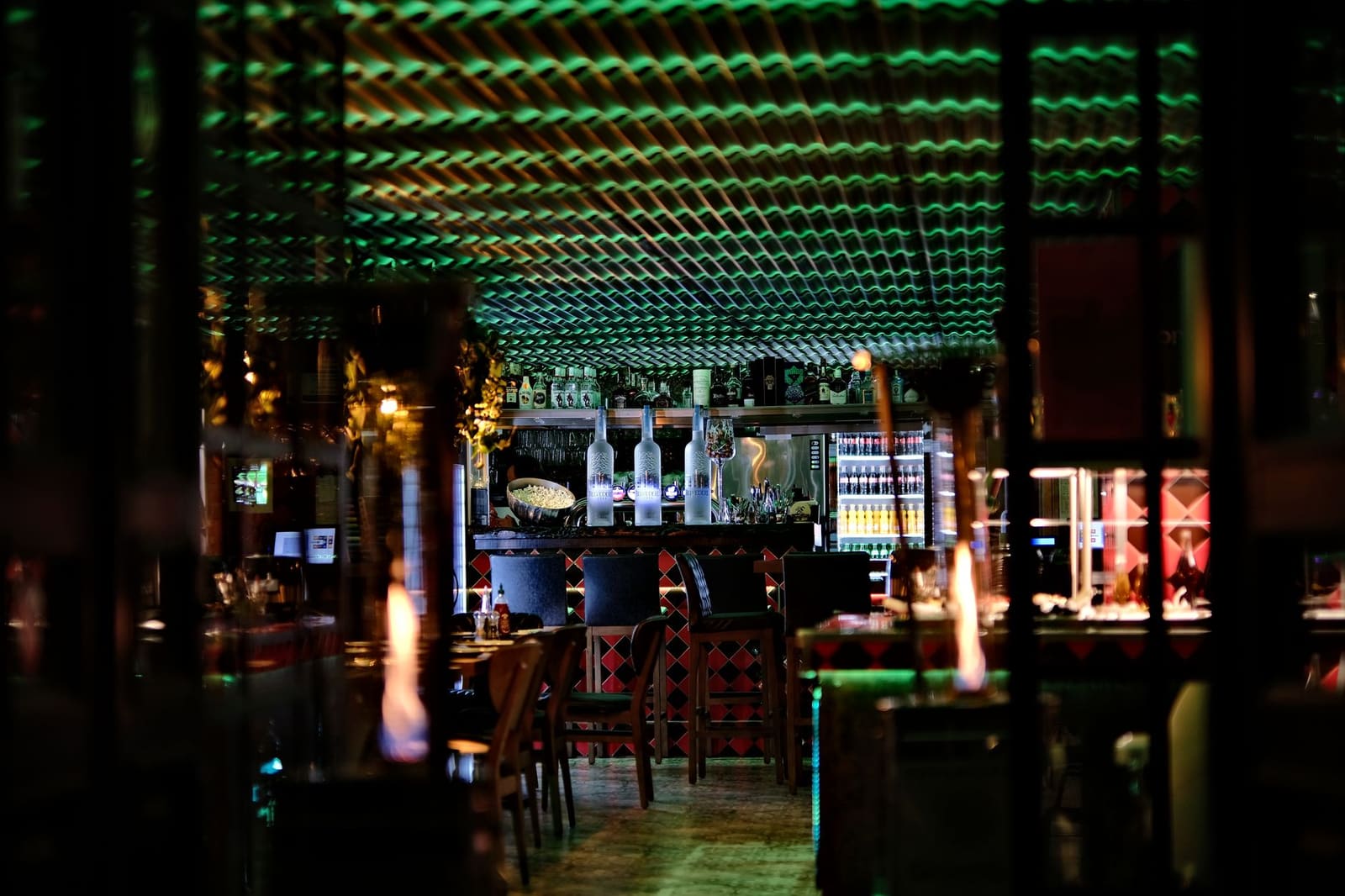 Sfeervol interieur van een cocktailbar met warme verlichting en verzamelde decoratie aan de muur
