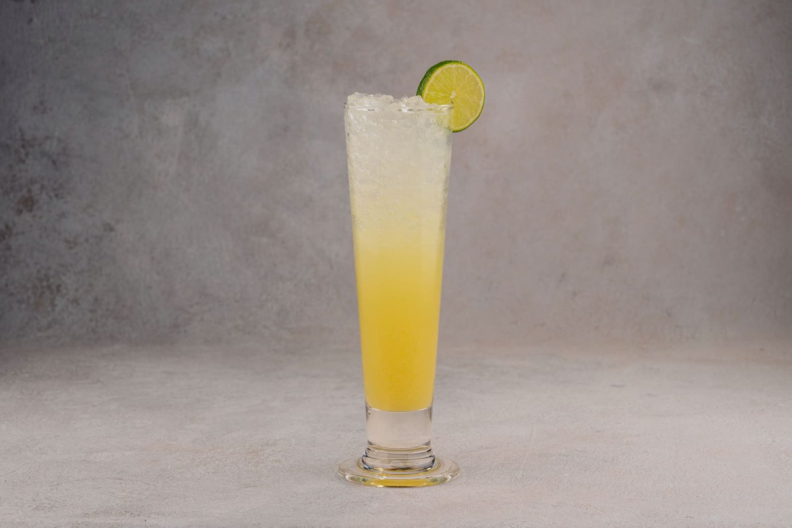 Gecrushed ijs in een zilveren glas met munt en een rietje op een bar