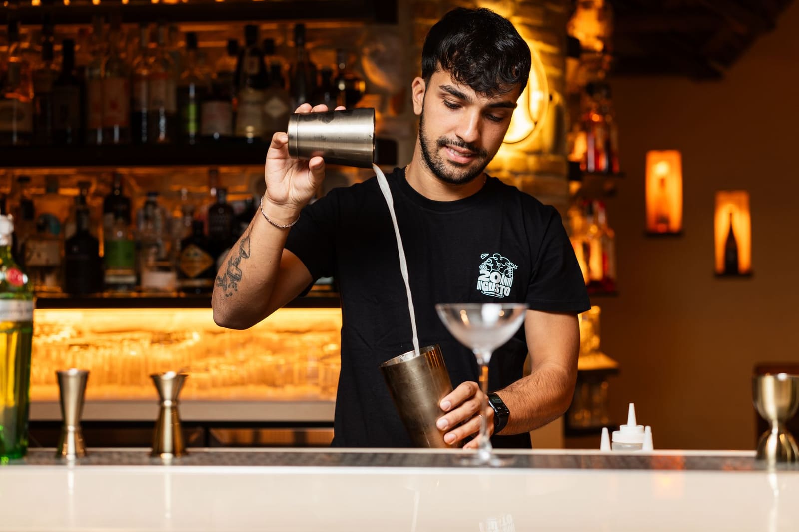 Bartender shaket een cocktail met plantaardige foamer voor een dikke schuimkraag